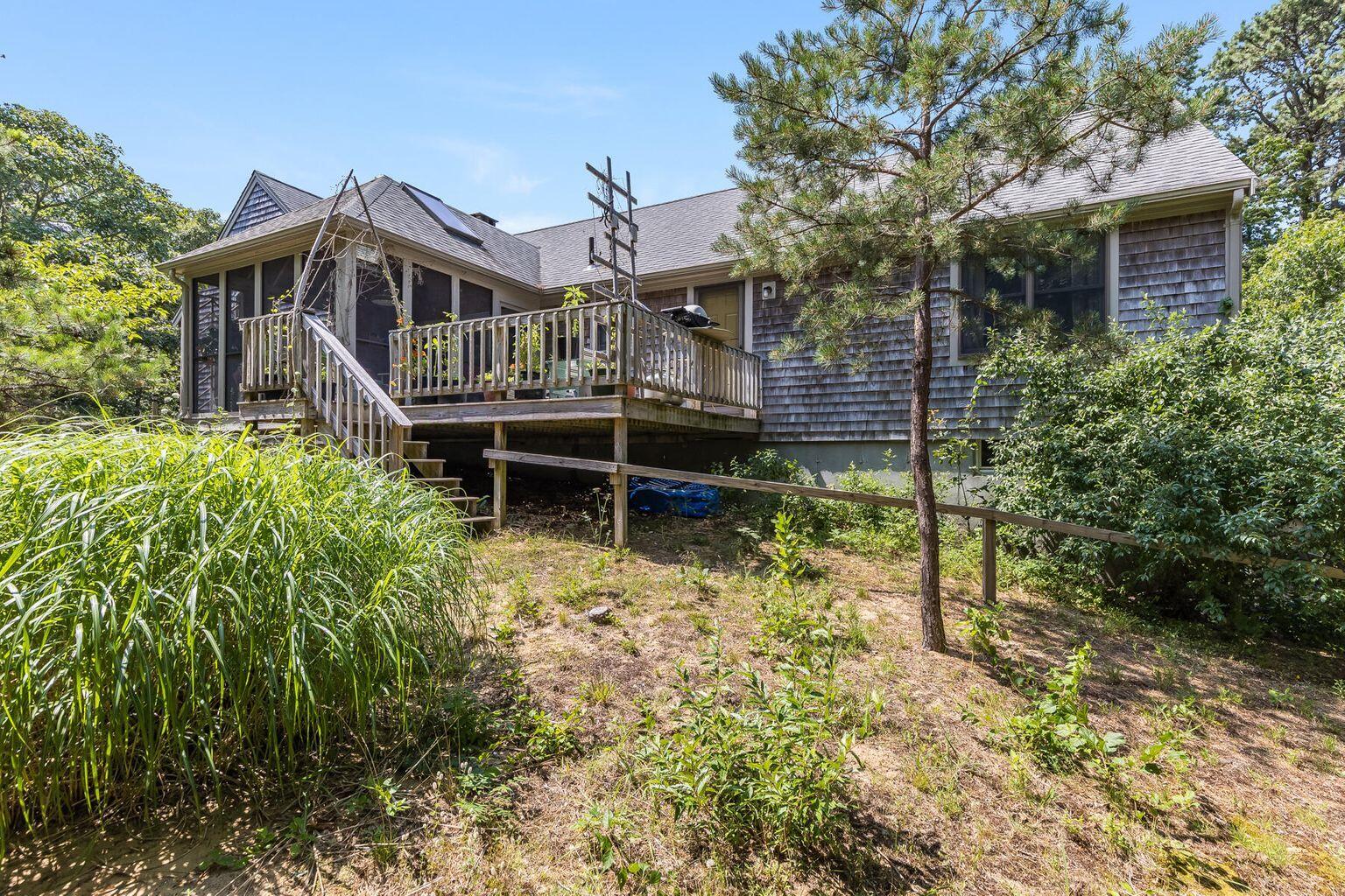 660 Hay Road Eastham, MA 02642 - Photo 3 of 48 a backyard of a house with table and chairs