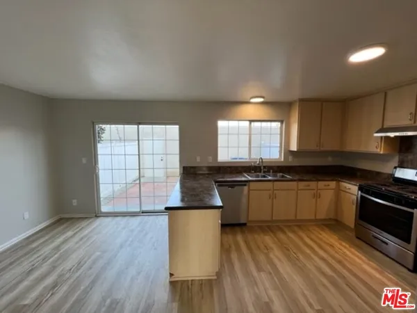 a large kitchen with lots of counter space and a sink