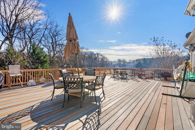 a large white bathroom with a large tub sink shower and mirror