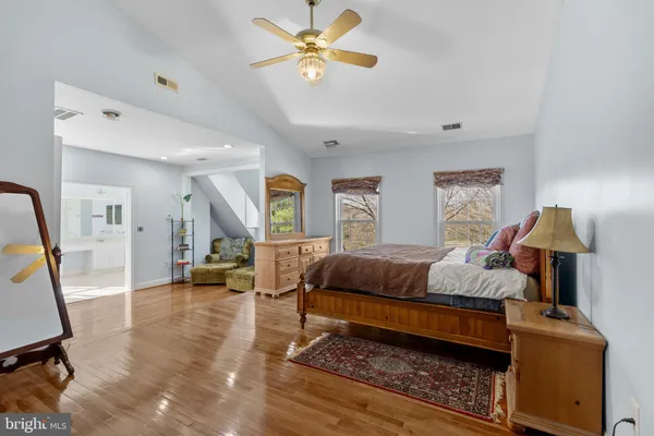 a bedroom with a bed and a dresser in it