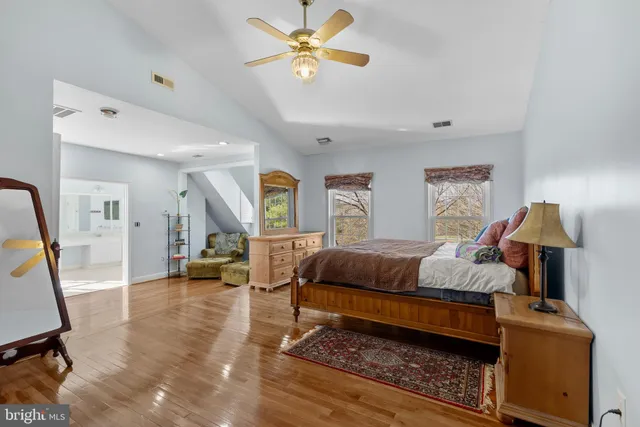 a bedroom with a bed and a dresser in it