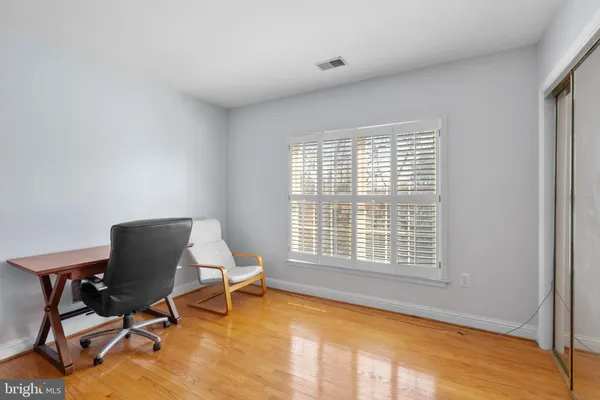 a large kitchen with stainless steel appliances kitchen island granite countertop a refrigerator and a sink
