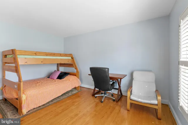 a bedroom with a bed and a mirror