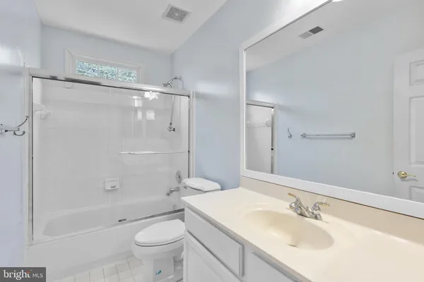 a bedroom with a bed and a chair