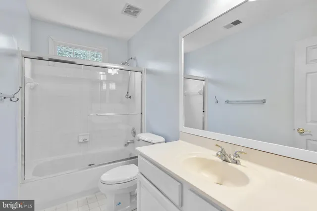 a bedroom with a bed and a chair