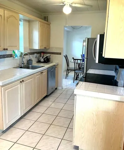 a kitchen with stainless steel appliances granite countertop a sink and a cabinets