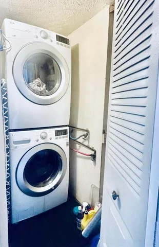 a living room with a floor to ceiling window and furniture