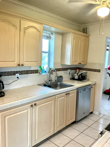 a kitchen with stainless steel appliances granite countertop a sink and a cabinets