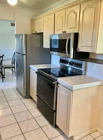 a kitchen with granite countertop a stove and a microwave