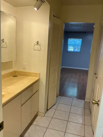 a bedroom with bed and wooden floor