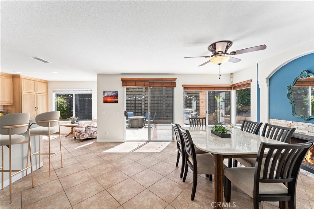 4150 San Ramon Drive Corona, CA 92882 - Photo 11 of 30 a view of a dining room with furniture large windows and wooden floor