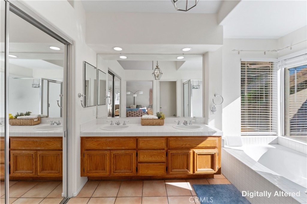 4150 San Ramon Drive Corona, CA 92882 - Photo 14 of 30 a bathroom with a granite countertop sink double vanity mirror and bathtub