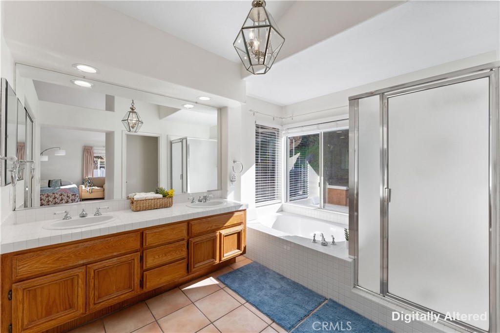 4150 San Ramon Drive Corona, CA 92882 - Photo 15 of 30 a bathroom with a tub sink and mirror