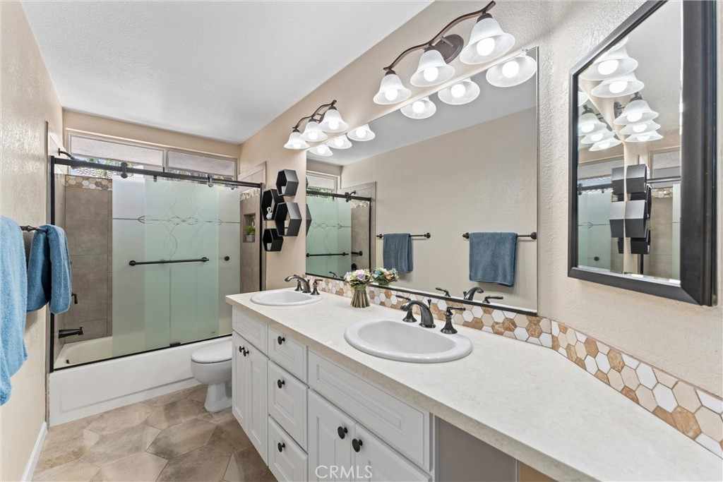 4150 San Ramon Drive Corona, CA 92882 - Photo 19 of 30 a bathroom with a double vanity sink mirror and shower