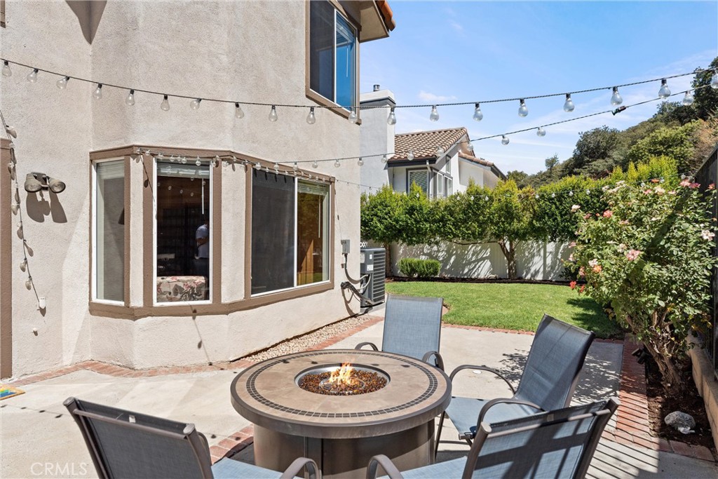 4150 San Ramon Drive Corona, CA 92882 - Photo 24 of 30 a view of a patio with table and chairs and potted plants