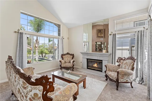 a living room with furniture fireplace and a window