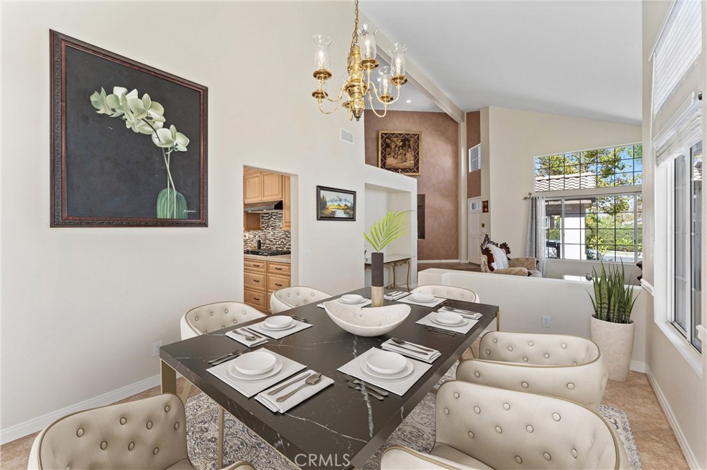 4150 San Ramon Drive Corona, CA 92882 - Photo 7 of 30 a view of a dining room with furniture a chandelier and wooden floor