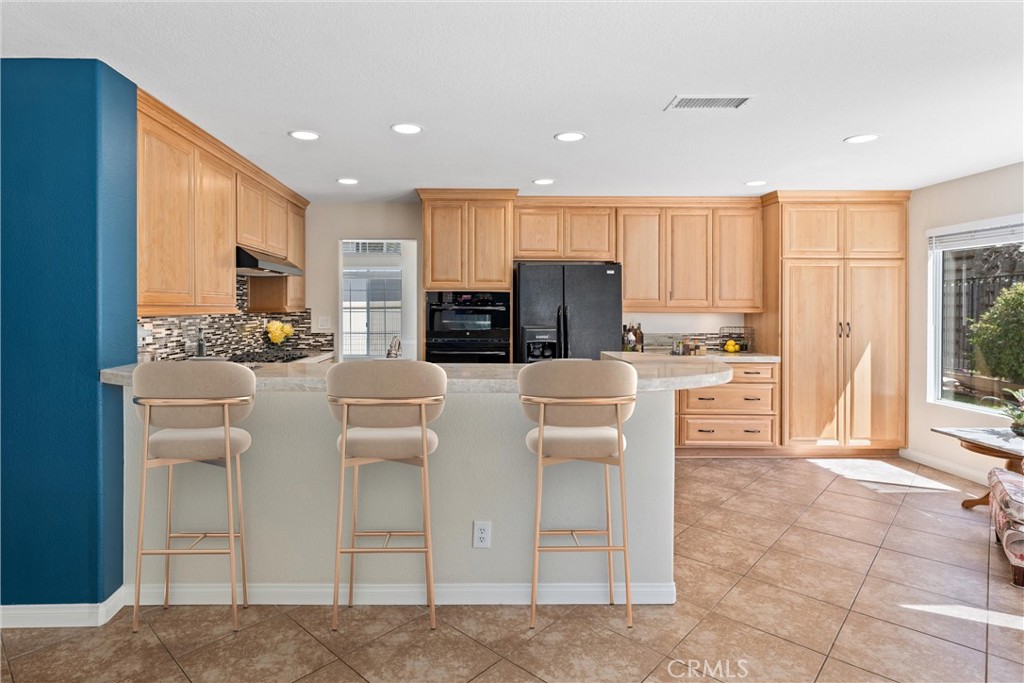4150 San Ramon Drive Corona, CA 92882 - Photo 8 of 30 a kitchen with stainless steel appliances kitchen island granite countertop a refrigerator and cabinets
