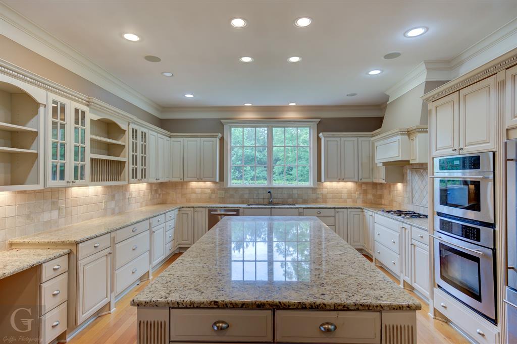 1212 WPA Road Homer, LA 71040 - Photo 26 of 35 Kitchen featuring a kitchen island, ornamental molding, a sink, stainless steel appliances, and light stone counters