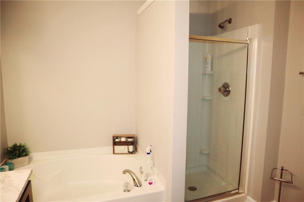 789 Celeste Lane Atlanta, GA 30331 - Photo 12 of 18 a bathroom with a bathtub and a shower