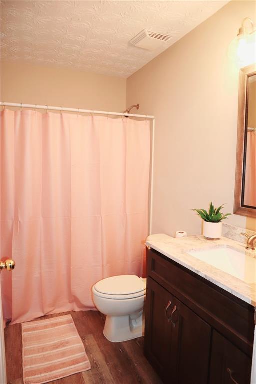 789 Celeste Lane Atlanta, GA 30331 - Photo 15 of 18 a bathroom with a granite countertop sink a toilet and a mirror