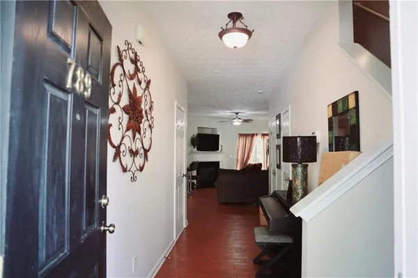 a living room with furniture and wooden floor