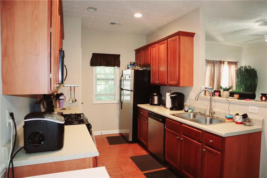 789 Celeste Lane Atlanta, GA 30331 - Photo 6 of 18 a kitchen with stainless steel appliances a sink stove and refrigerator