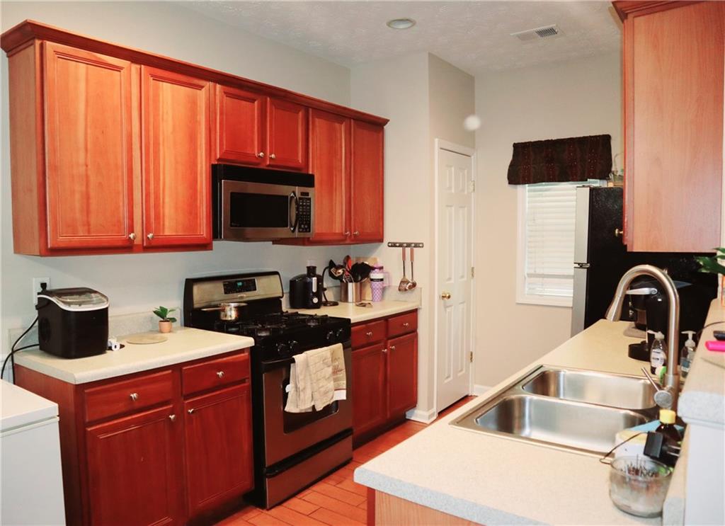 789 Celeste Lane Atlanta, GA 30331 - Photo 7 of 18 a kitchen with a sink and a stove top oven
