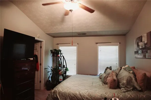 a bedroom with a bed and a flat tv screen