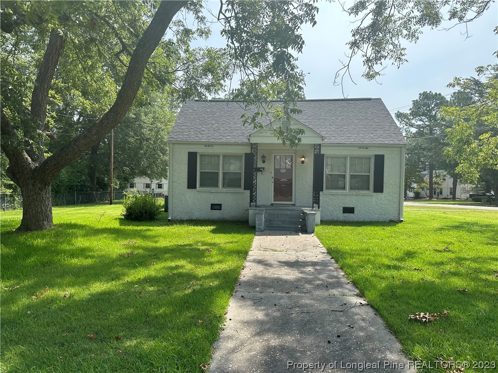 202 North Bethel Road Raeford, NC 28376 - Photo 1 of 15 a front view of a house with a yard and garden