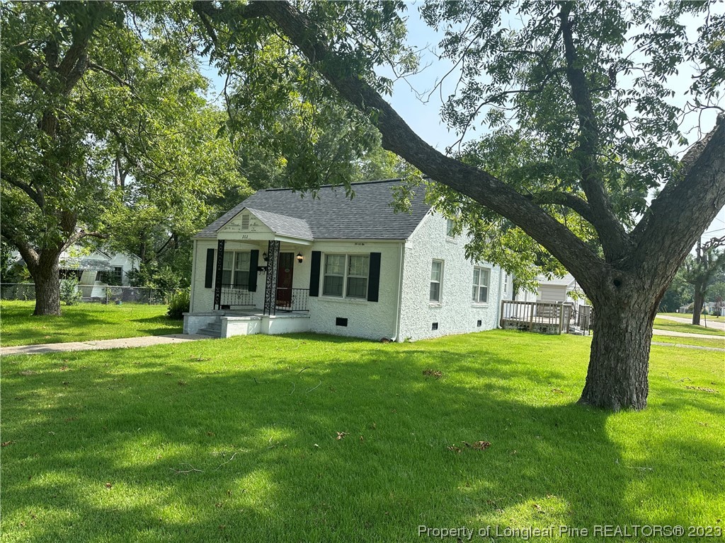 202 North Bethel Road Raeford, NC 28376 - Photo 2 of 15 a front view of a house with a garden