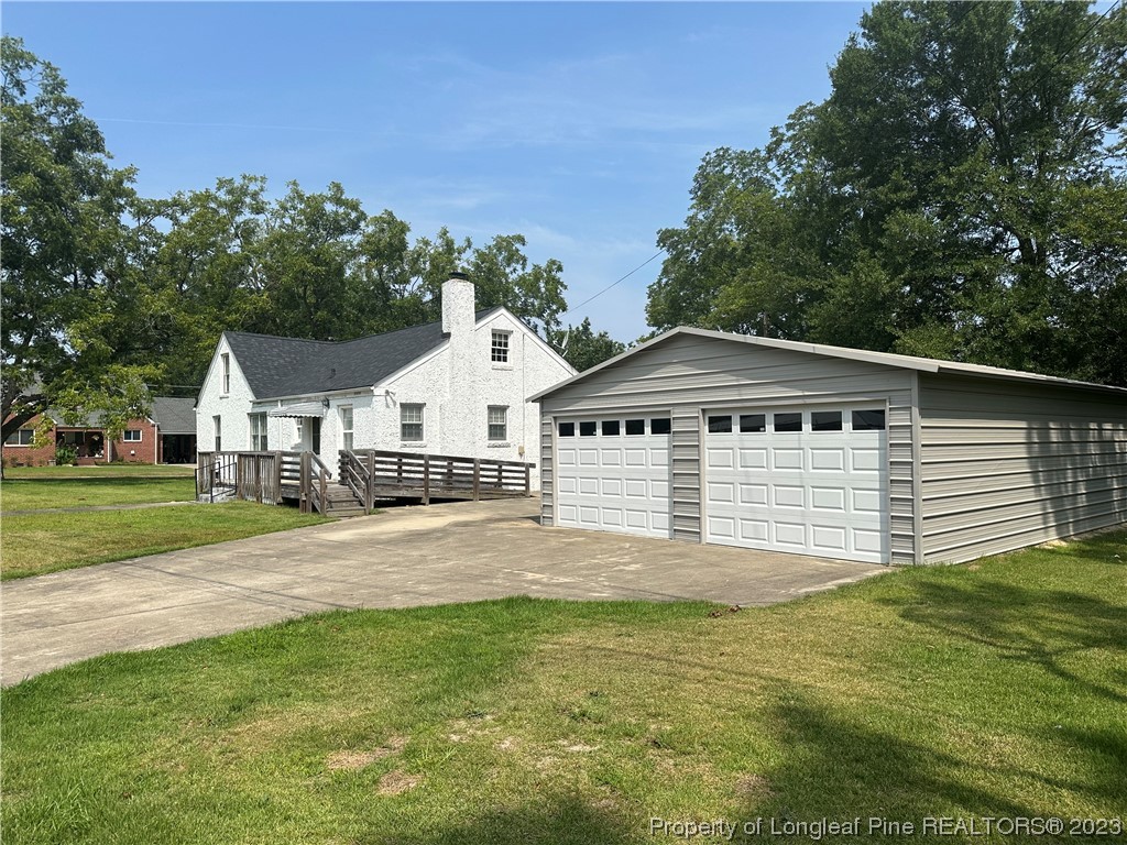 202 North Bethel Road Raeford, NC 28376 - Photo 4 of 15 a front view of a house with a yard and garage