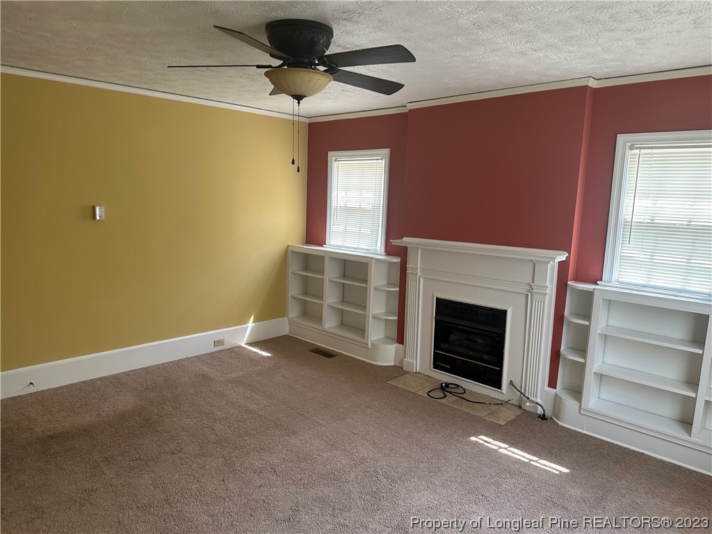 202 North Bethel Road Raeford, NC 28376 - Photo 6 of 15 a view of an empty room with a fireplace and a window