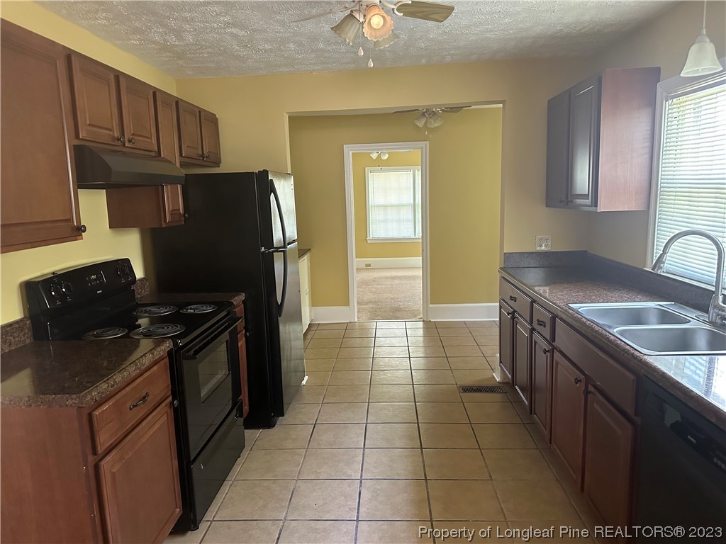 202 North Bethel Road Raeford, NC 28376 - Photo 7 of 15 a kitchen with a stove sink and refrigerator