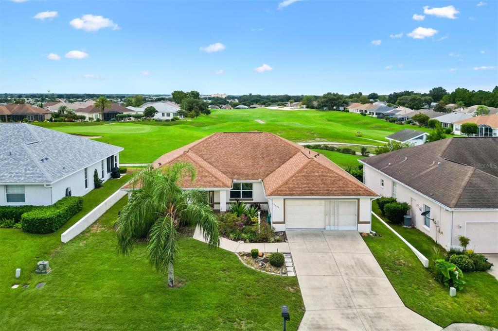 a aerial view of a house with a yard and plants