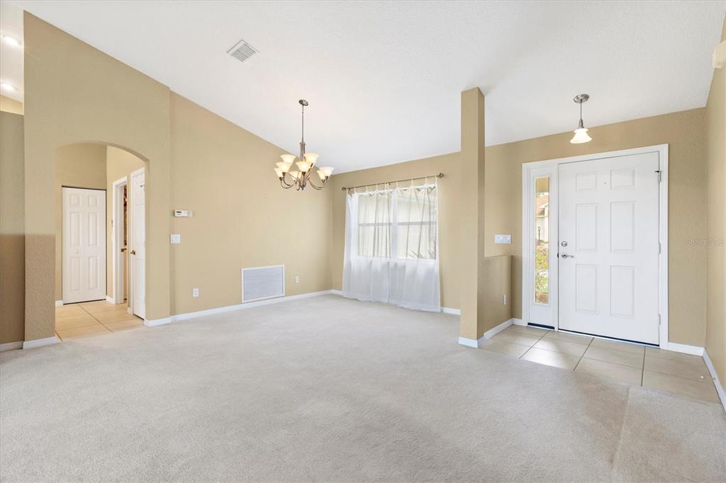 17083 Southeast 115th Terrace Road Summerfield, FL 34491 - Photo 7 of 43 a view of a big room with windows and chandelier fan