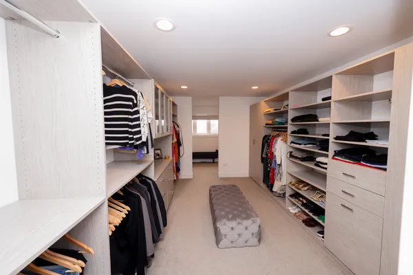 a view of walk in closet with clothes