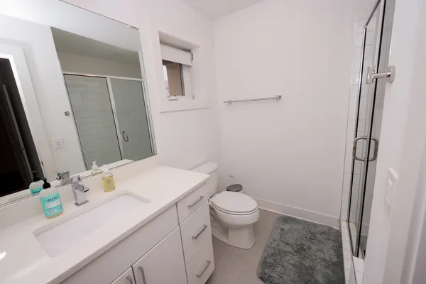 a bed sitting in a bedroom next to a bathroom
