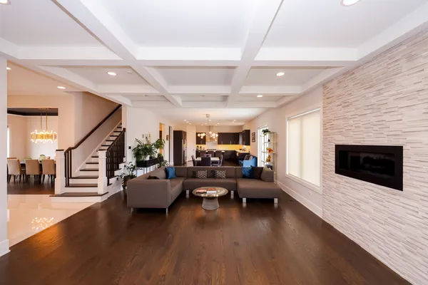 a living room with dining table furniture and a chandelier