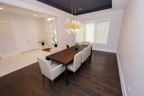 a living room with furniture a flat screen tv and kitchen view