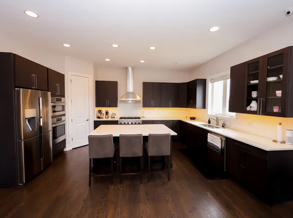 a living room with furniture and a dining table with kitchen view