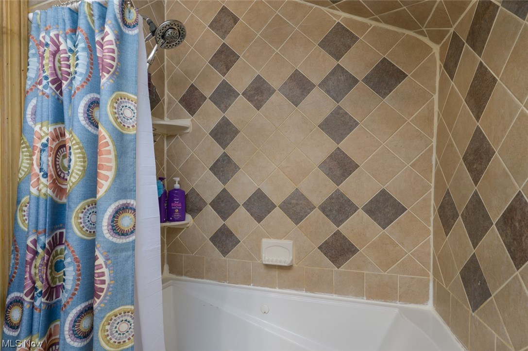 6132 North Canterbury Road Parma, OH 44129 - Photo 31 of 34 Bathroom with shower / bathtub combination, ceramic tile with curtain