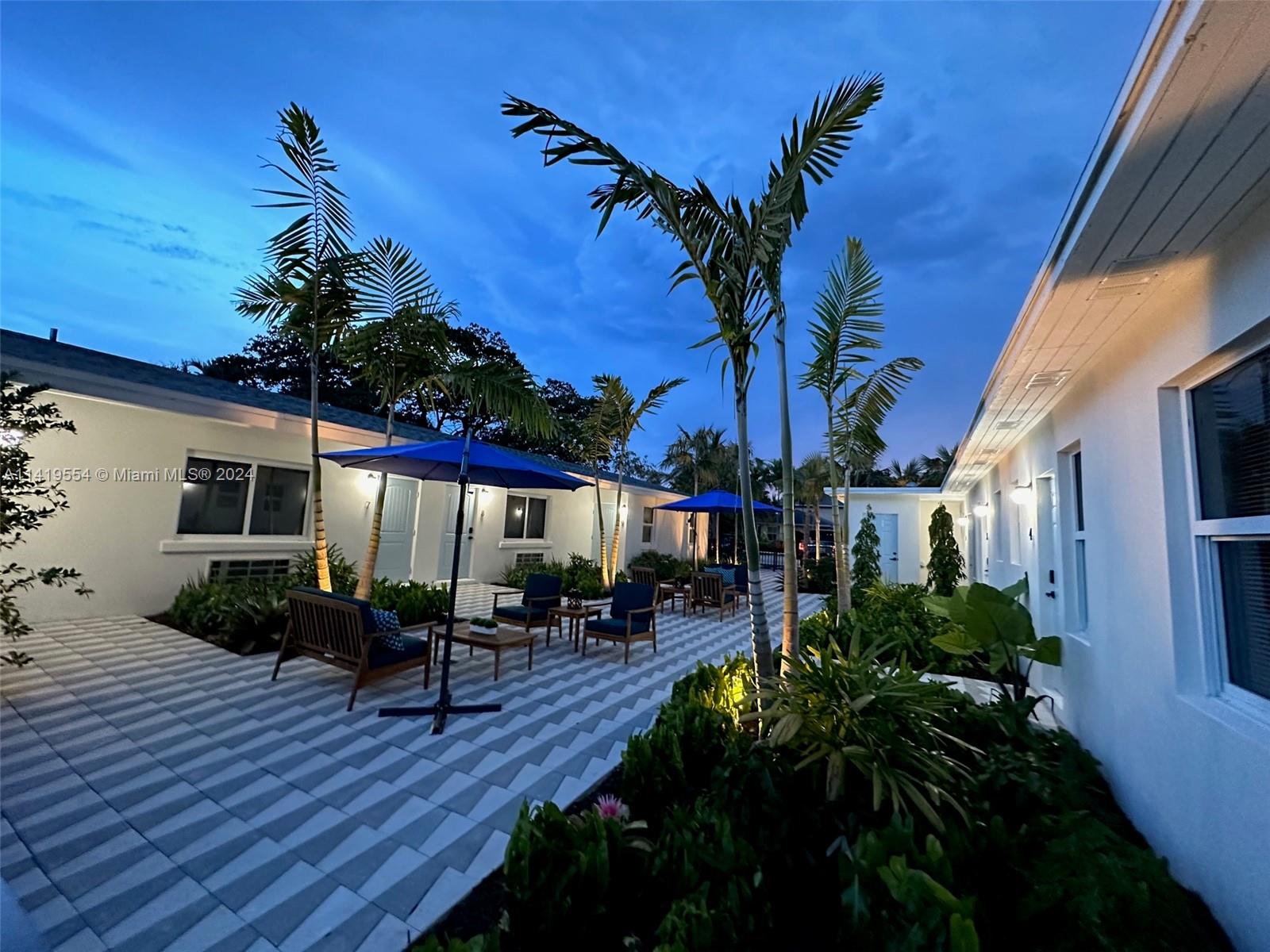 Palm Trail Delray Beach, FL 33483 - Photo 12 of 55 a backyard of a house with wooden floor table and chairs