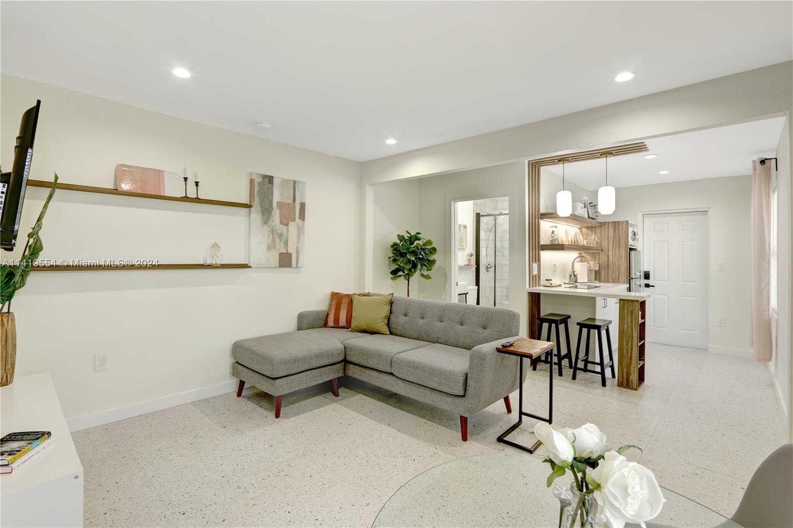 Palm Trail Delray Beach, FL 33483 - Photo 15 of 55 a living room with furniture and a chandelier