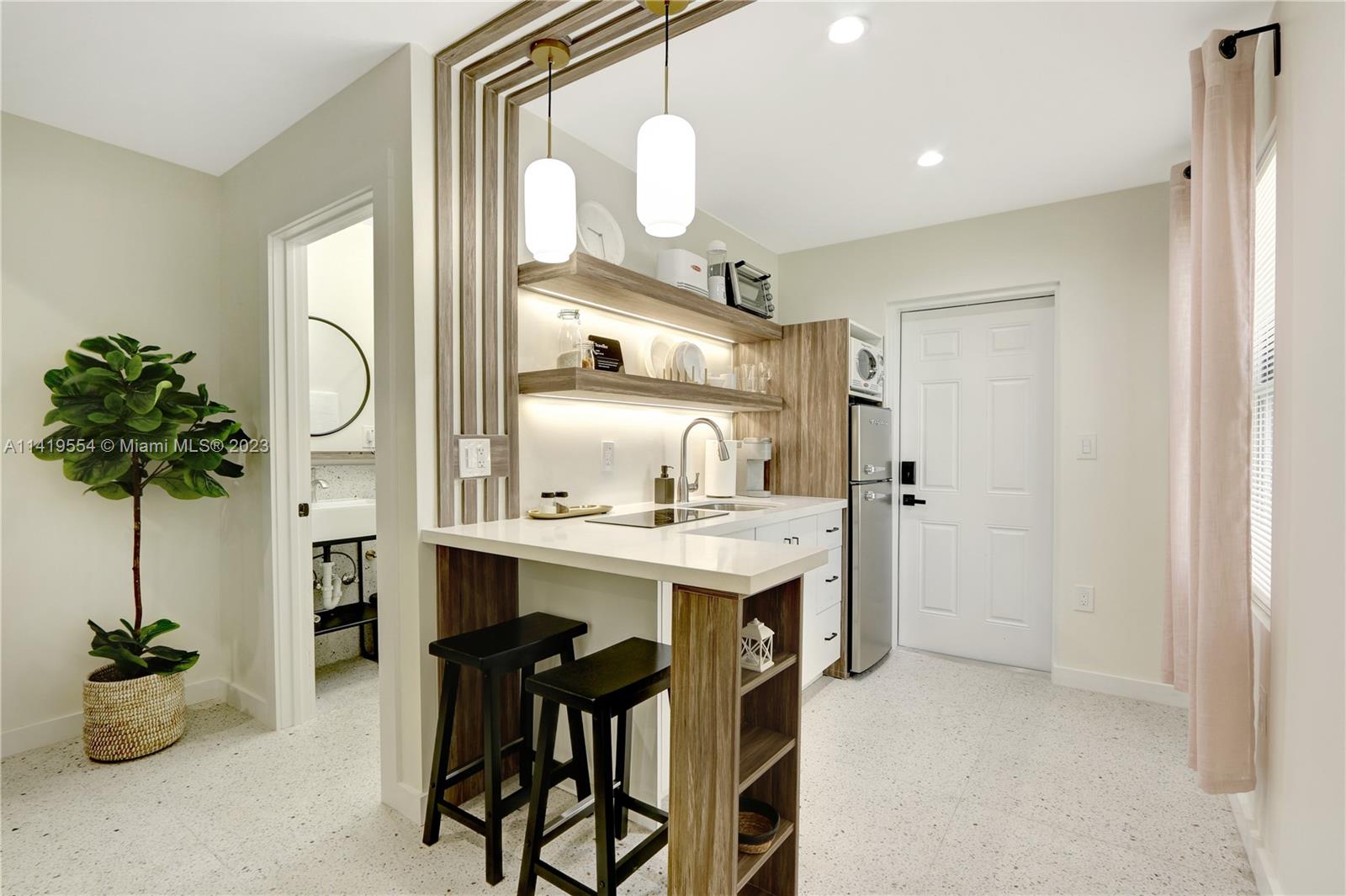 Palm Trail Delray Beach, FL 33483 - Photo 16 of 55 a kitchen with cabinets and window