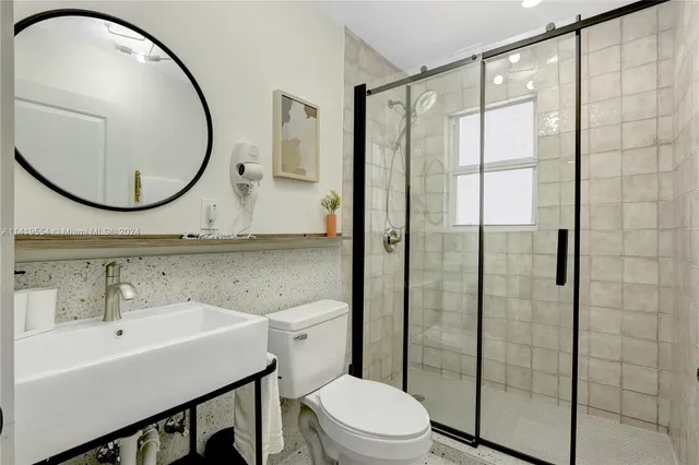a kitchen with white cabinets and white refrigerator