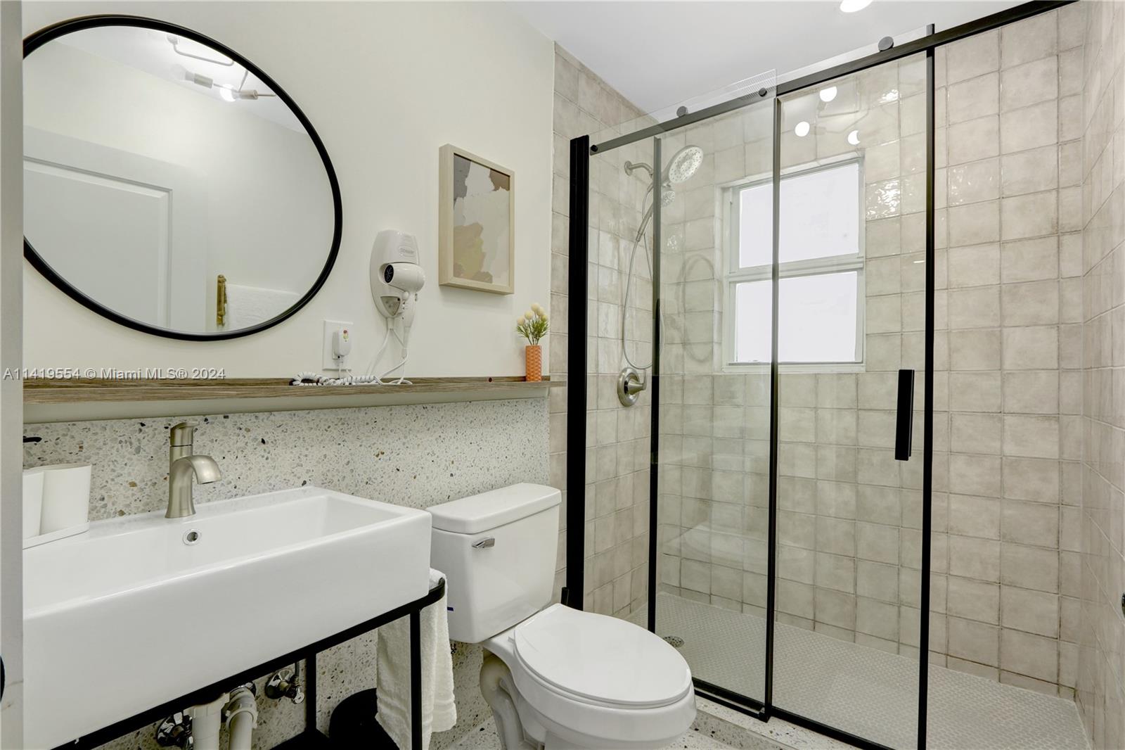 Palm Trail Delray Beach, FL 33483 - Photo 18 of 55 a bathroom with a sink a toilet and a mirror