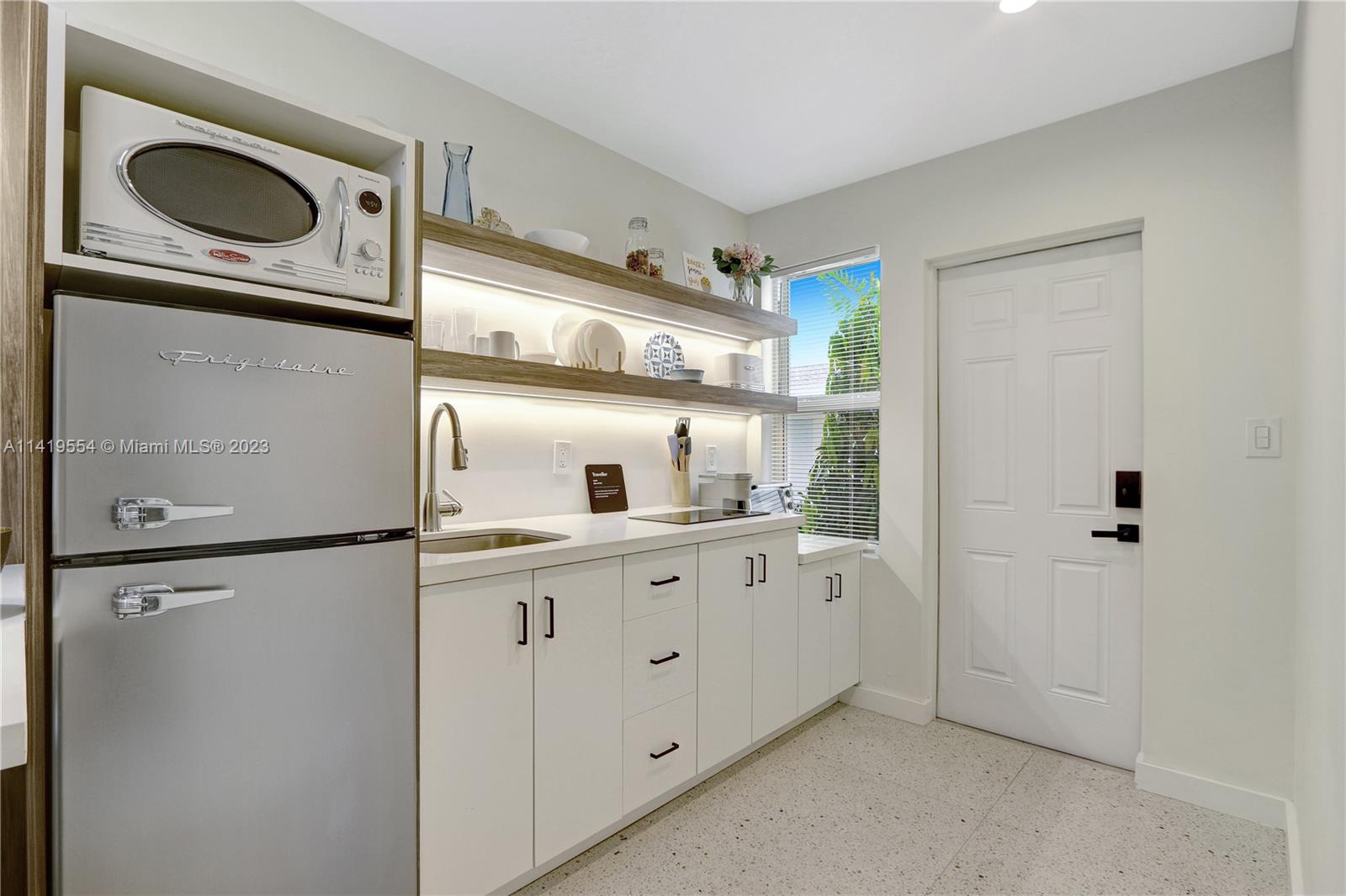 Palm Trail Delray Beach, FL 33483 - Photo 21 of 55 a kitchen with white cabinets and white refrigerator