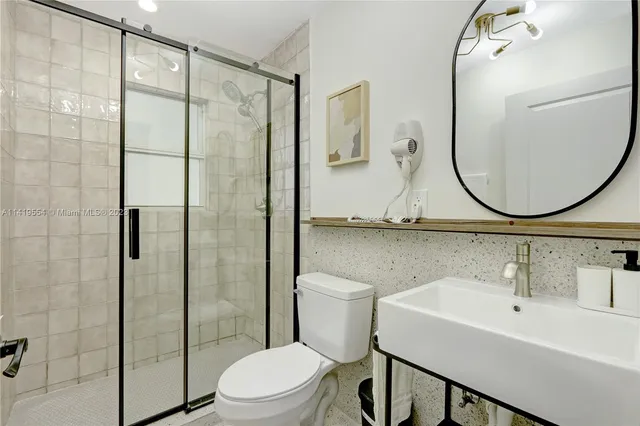 a bathroom with a toilet sink and shower