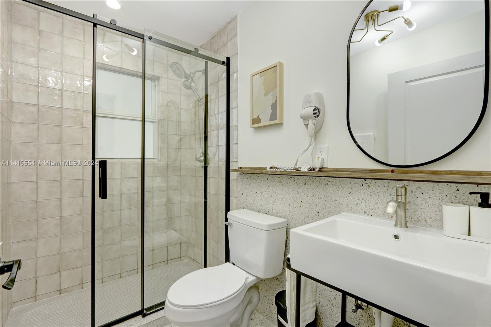 Palm Trail Delray Beach, FL 33483 - Photo 30 of 55 a bathroom with a sink a toilet and a mirror